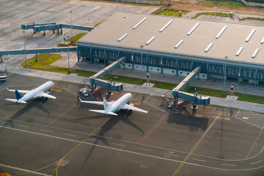 Aerial view of an international coastal airport with complex taxiways