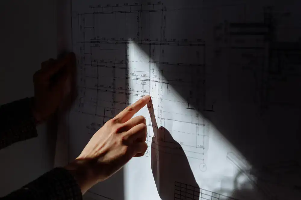 Architectural blueprints of an airport terminal alongside 3D wireframe models